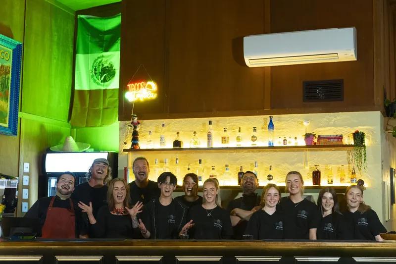 The La Catrina crew together at the bar